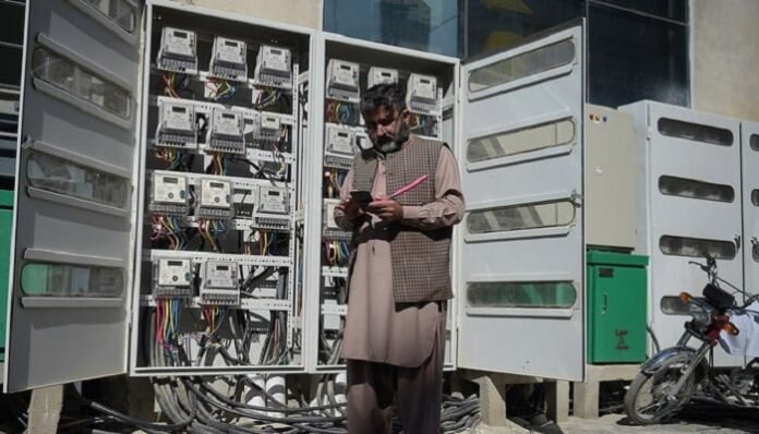 An employee of the state-run Islamabad Electric Supply Company takes a meter reading with his smartphone